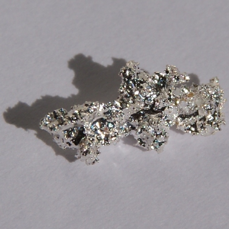Silver — Natural silver nugget, 1 cm long.